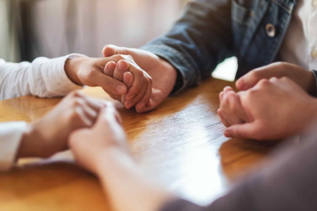 group-of-people-sitting-in-a-circle-holding-hands-2026-03-16-00-38-25-utc (1)