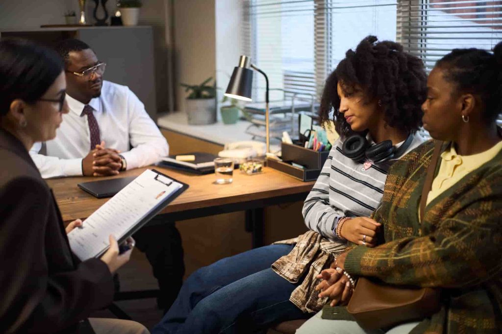 Middle-aged man and young woman talking in a meeting